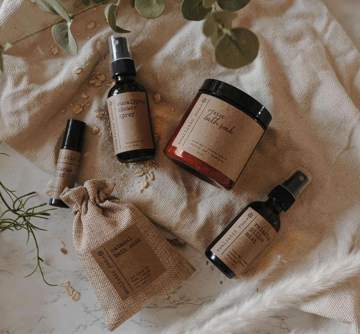 Soulistic Root Spa Gift Set flat lay with sprays, roller, jar and bath soak bag